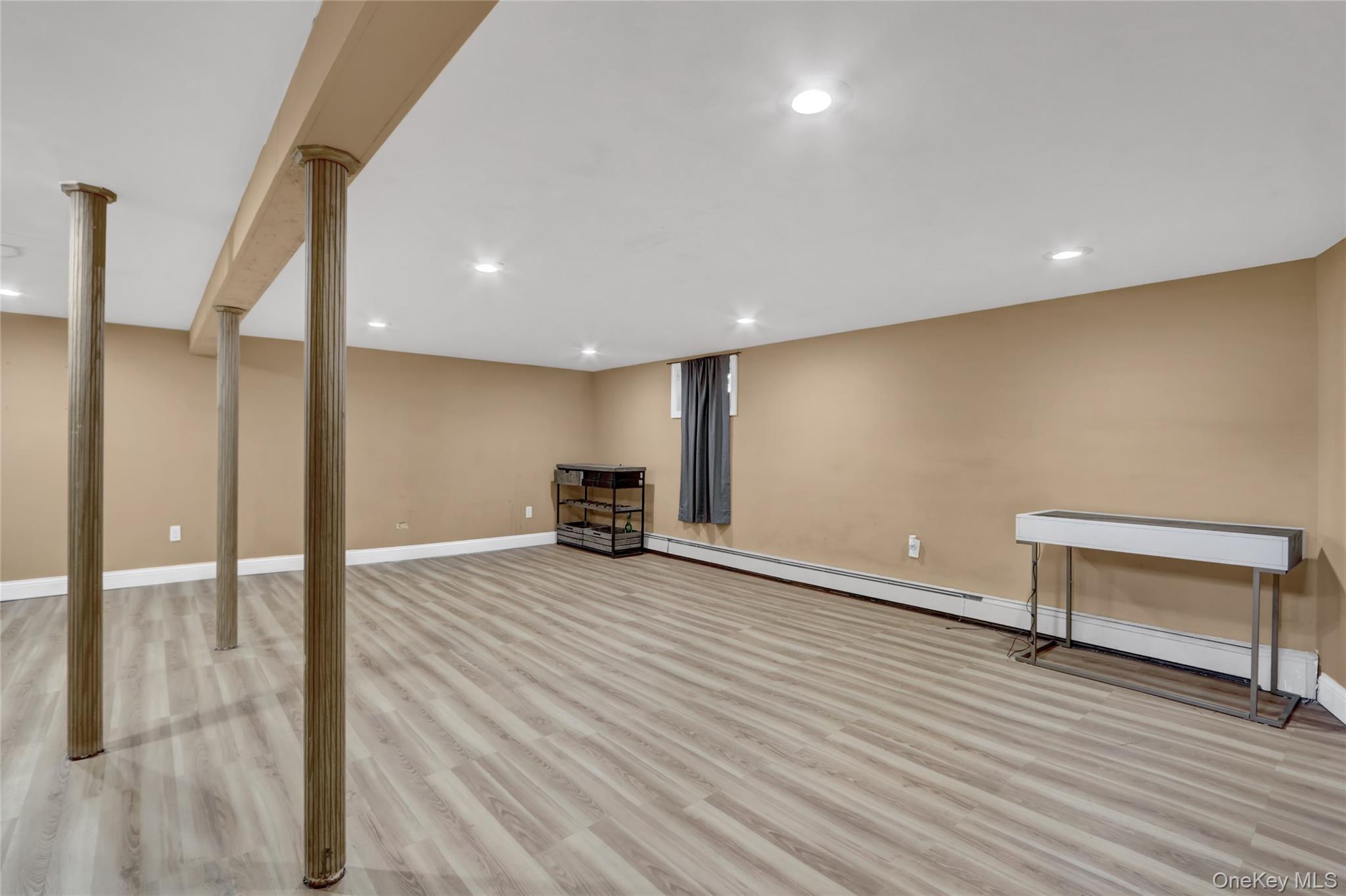 600 Plainview Road Plainview, NY 11803 - Photo 33 of 41 a view of an empty room with wooden floor and a window