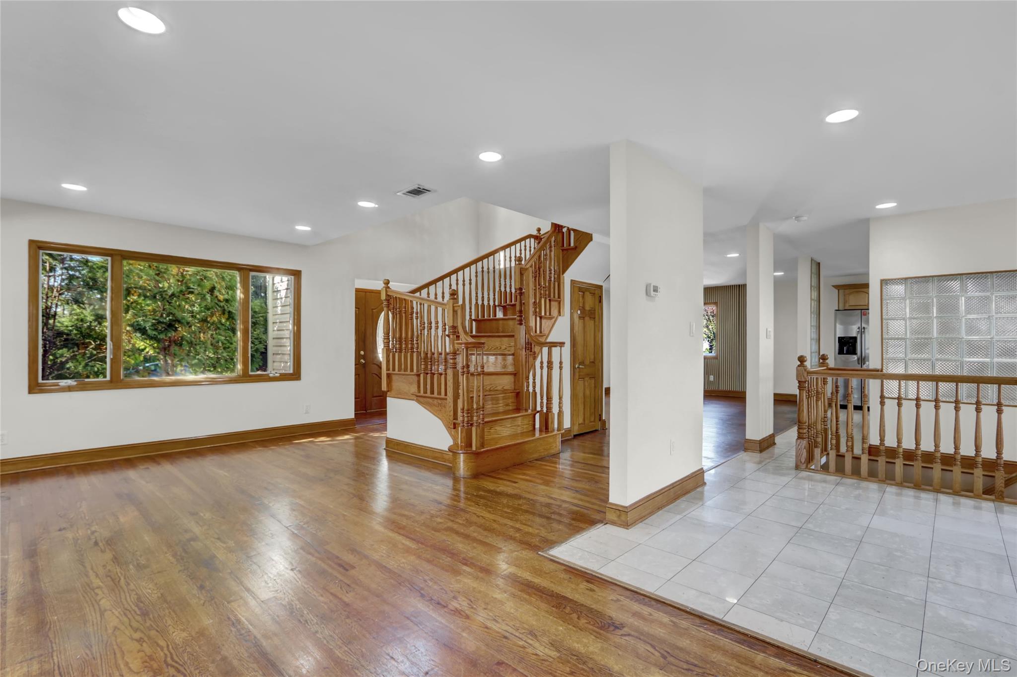600 Plainview Road Plainview, NY 11803 - Photo 7 of 41 a view of an empty room with wooden floor and windows