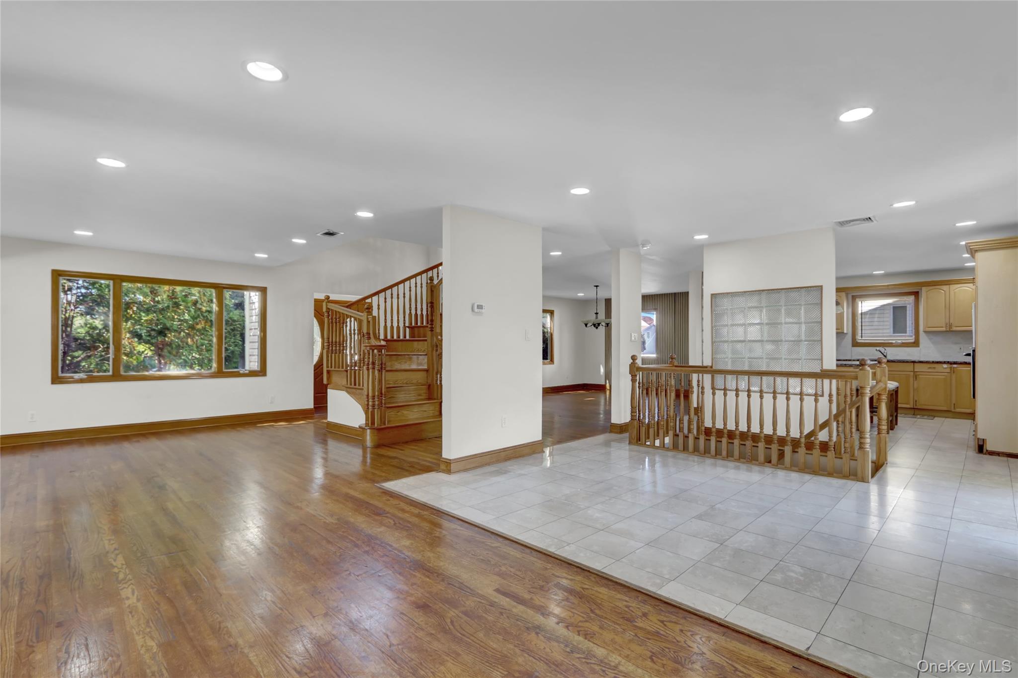 600 Plainview Road Plainview, NY 11803 - Photo 8 of 41 an empty room with wooden floor and windows