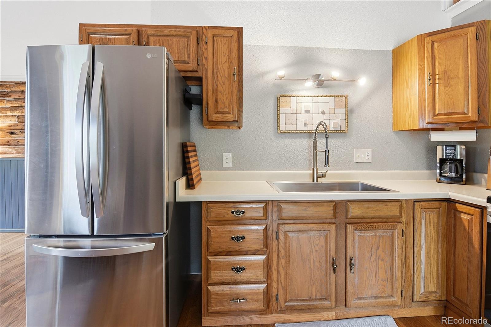 185 Alice Road Idaho Springs, CO 80452 - Photo 10 of 43 a kitchen with stainless steel appliances a refrigerator and cabinets