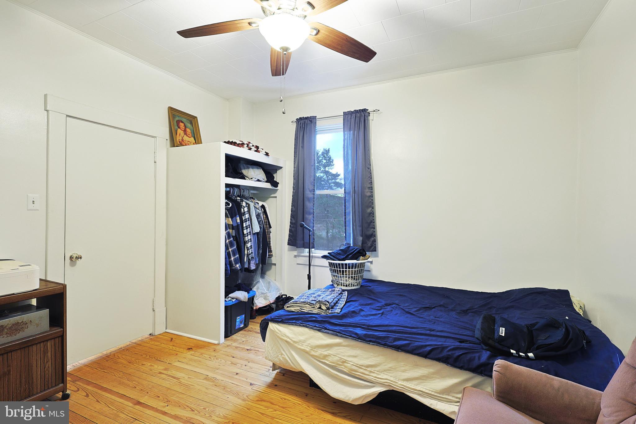 11305 Creek Road Southeast Cumberland, MD 21502 - Photo 11 of 47 a bedroom with a bed and a chandelier