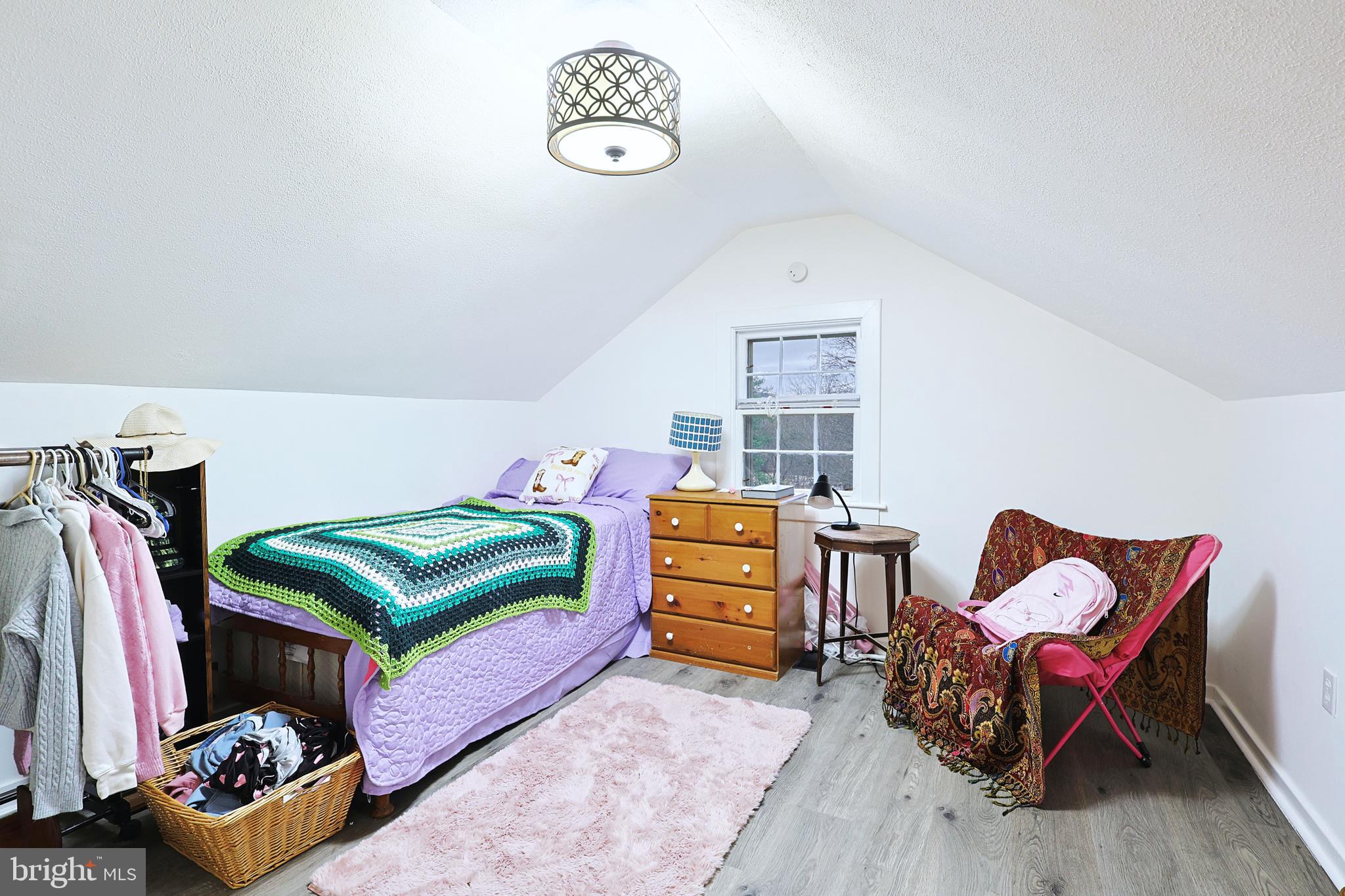 11305 Creek Road Southeast Cumberland, MD 21502 - Photo 22 of 47 a bedroom with a bed and a chandelier
