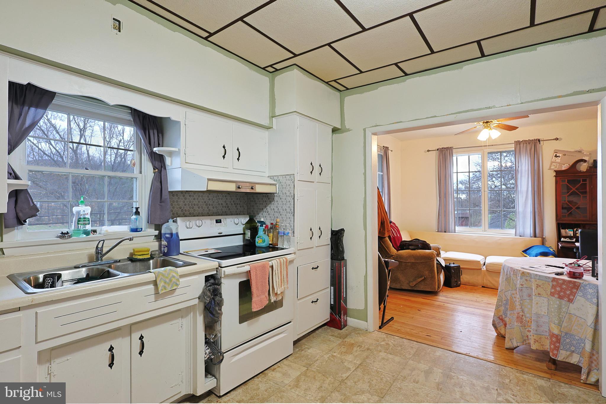 11305 Creek Road Southeast Cumberland, MD 21502 - Photo 3 of 47 a kitchen that has a lot of cabinets and wooden floor