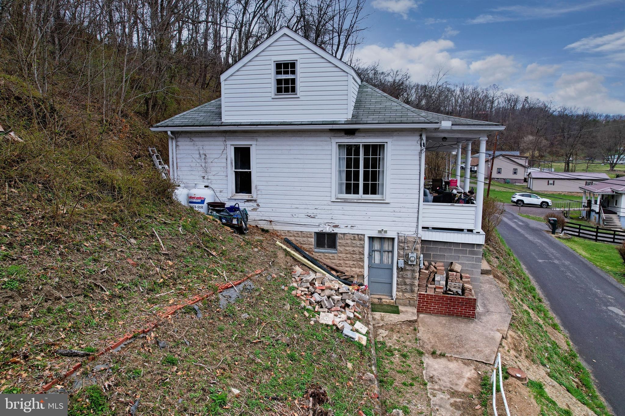 11305 Creek Road Southeast Cumberland, MD 21502 - Photo 37 of 47 a view of house with yard outdoor seating and barbeque oven