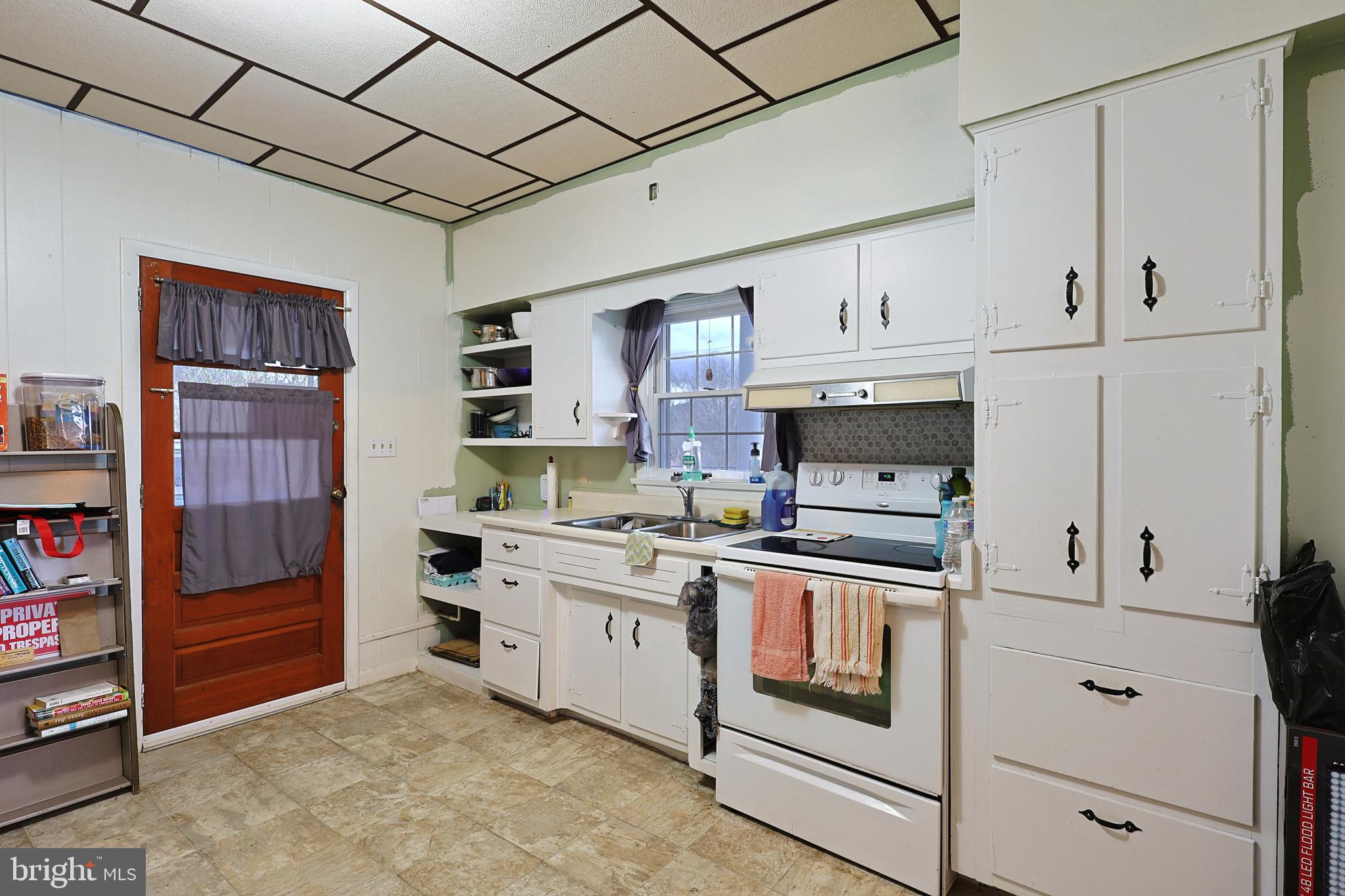 11305 Creek Road Southeast Cumberland, MD 21502 - Photo 4 of 47 a kitchen with stainless steel appliances granite countertop a refrigerator a stove and white cabinets