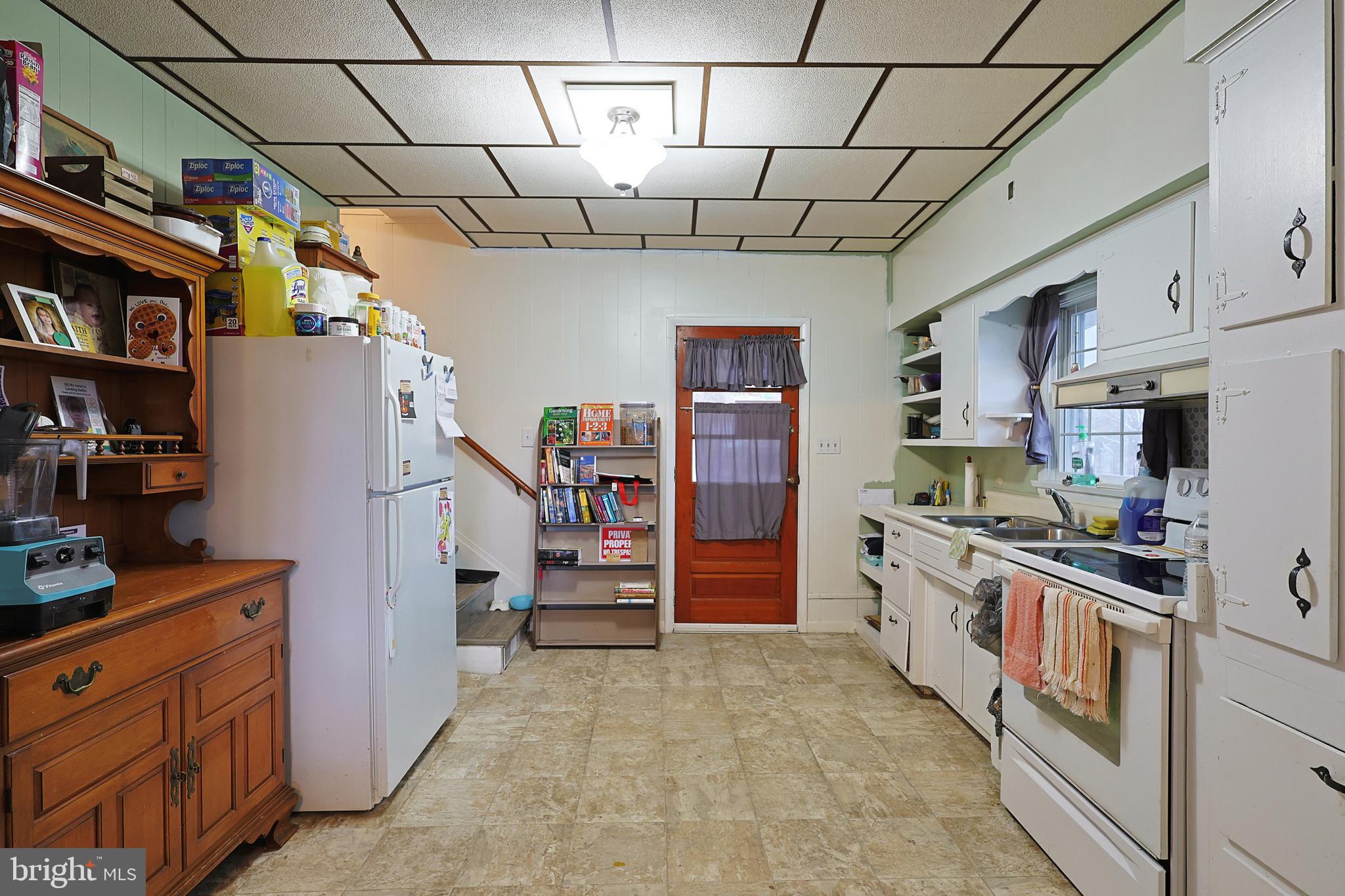 11305 Creek Road Southeast Cumberland, MD 21502 - Photo 5 of 47 a kitchen with stainless steel appliances granite countertop a refrigerator and a stove top oven