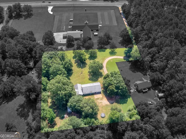 an aerial view of a house with a yard