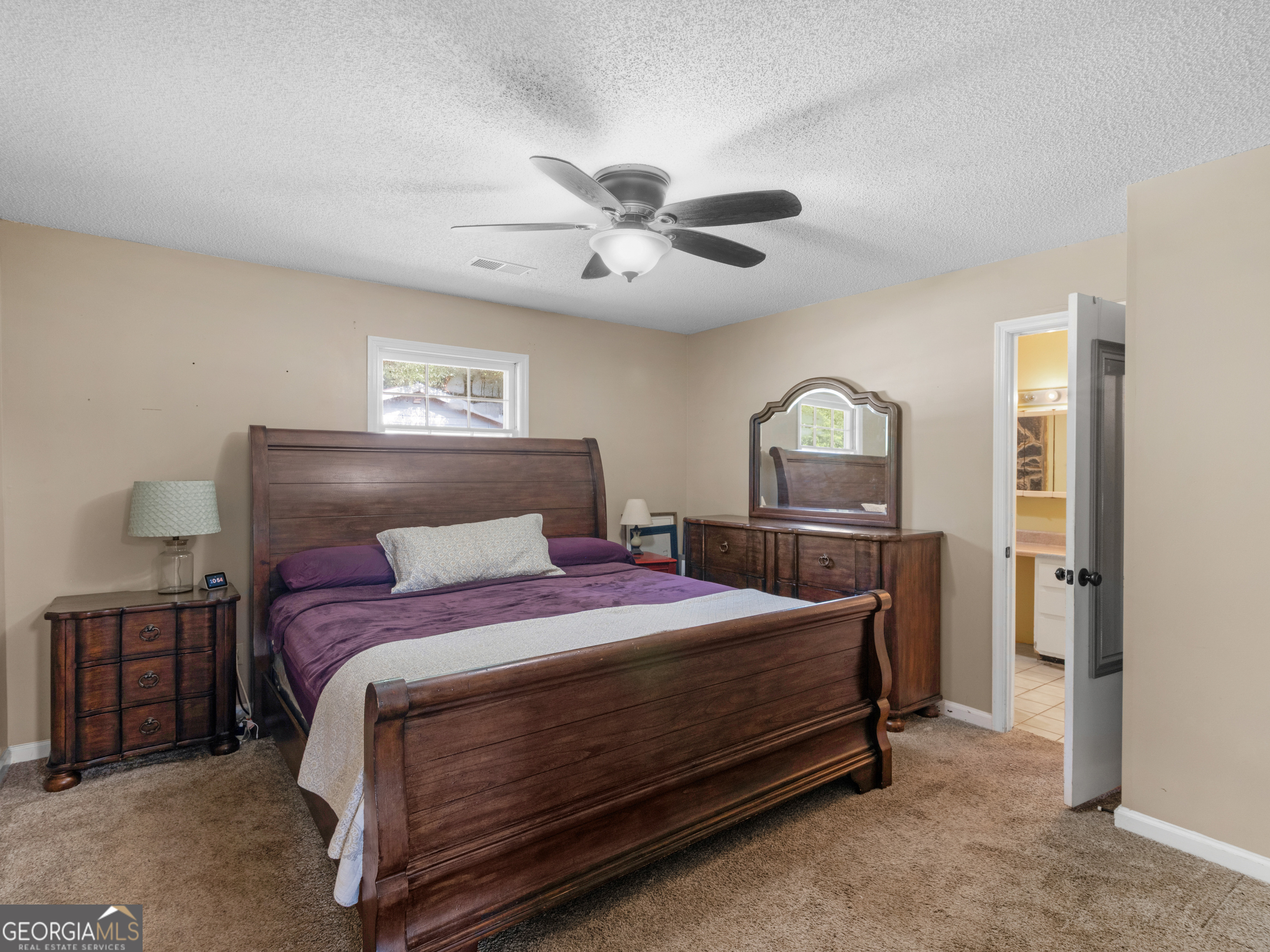 4939 Highway 19 Zebulon, GA 30295 - Photo 24 of 70 a bedroom with a bed and a chandelier