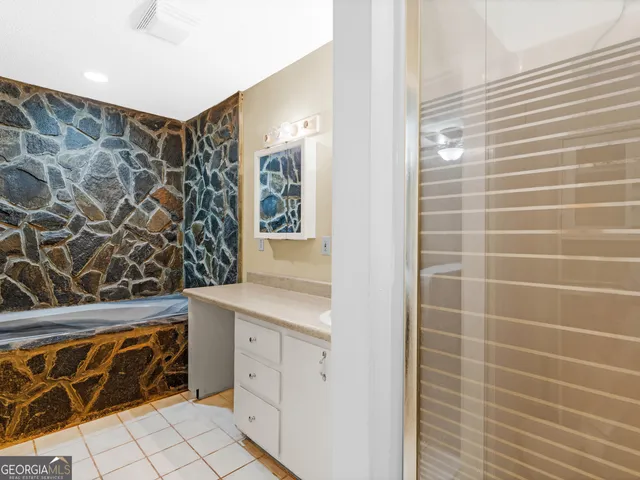 a bathroom with a sink a toilet and shower curtain