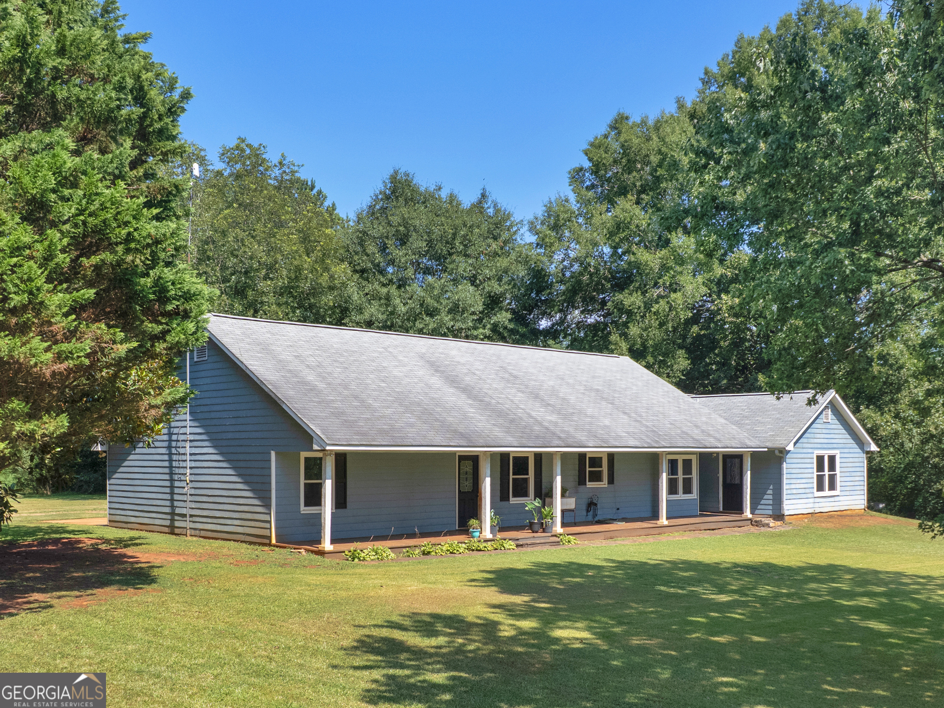 4939 Highway 19 Zebulon, GA 30295 - Photo 3 of 70 a front view of a house with a garden
