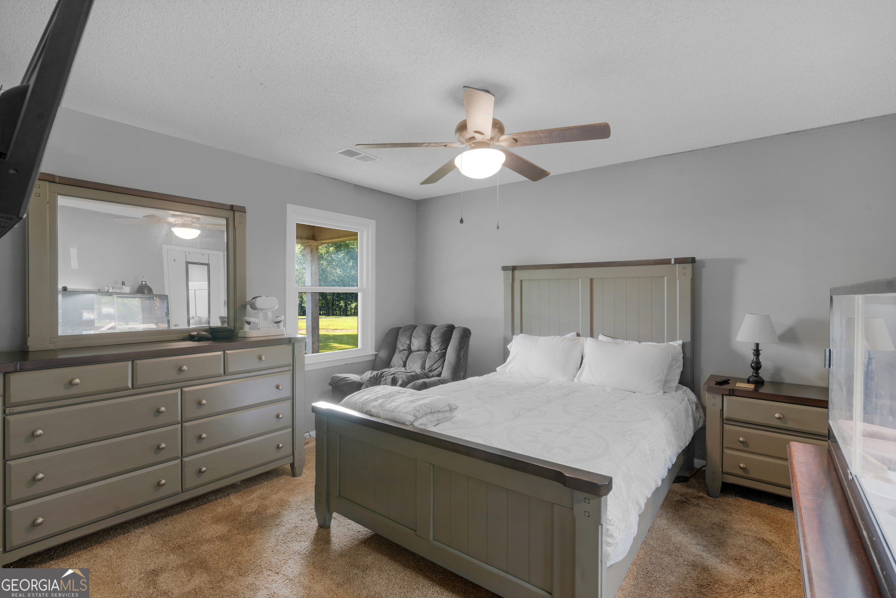 4939 Highway 19 Zebulon, GA 30295 - Photo 31 of 70 a bedroom with a large bed and a chandelier