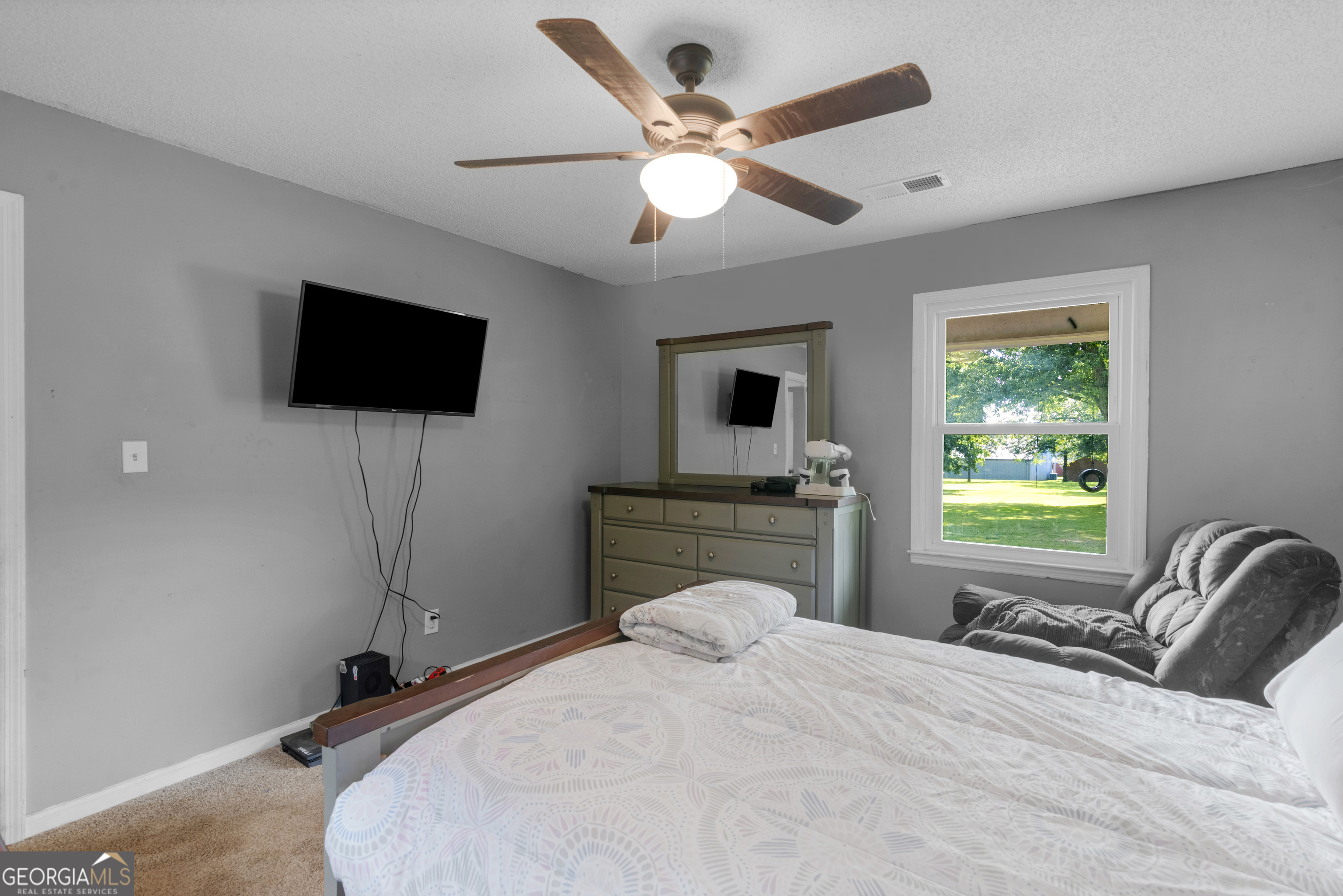 4939 Highway 19 Zebulon, GA 30295 - Photo 33 of 70 a bedroom with a bed and a flat screen tv