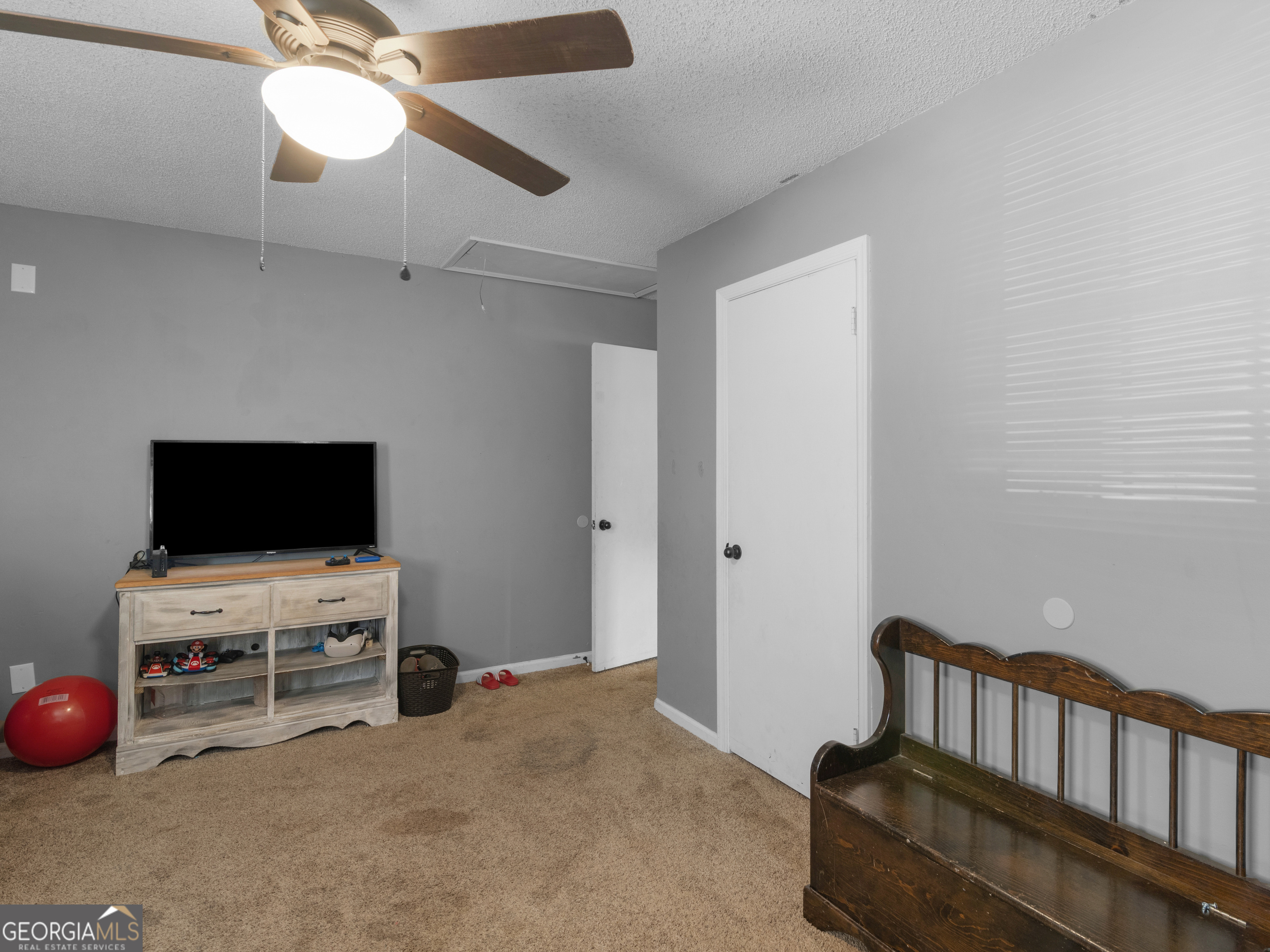 4939 Highway 19 Zebulon, GA 30295 - Photo 37 of 70 a bedroom with furniture and a flat screen tv