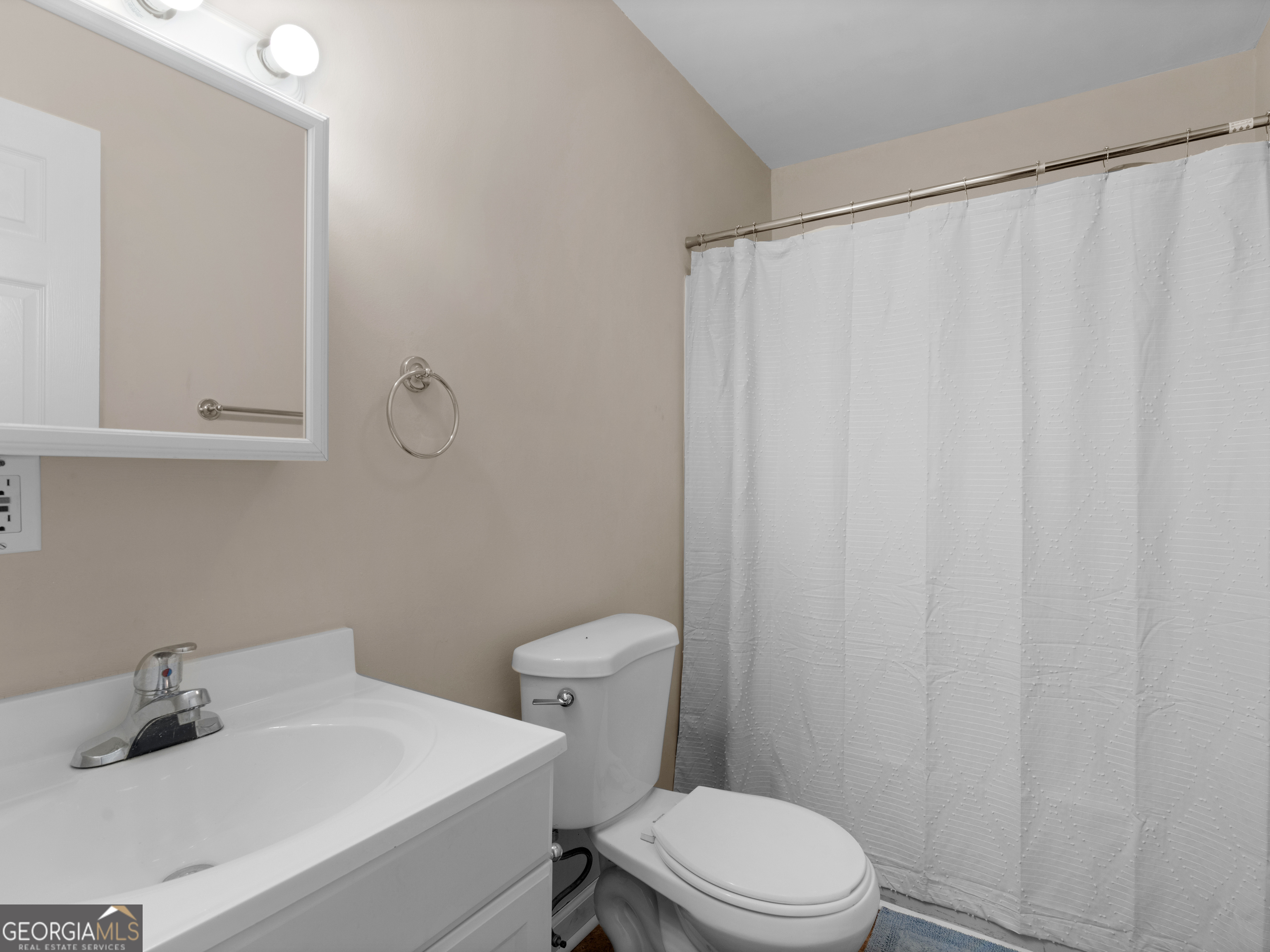 4939 Highway 19 Zebulon, GA 30295 - Photo 38 of 70 a bathroom with a sink a toilet and shower curtain