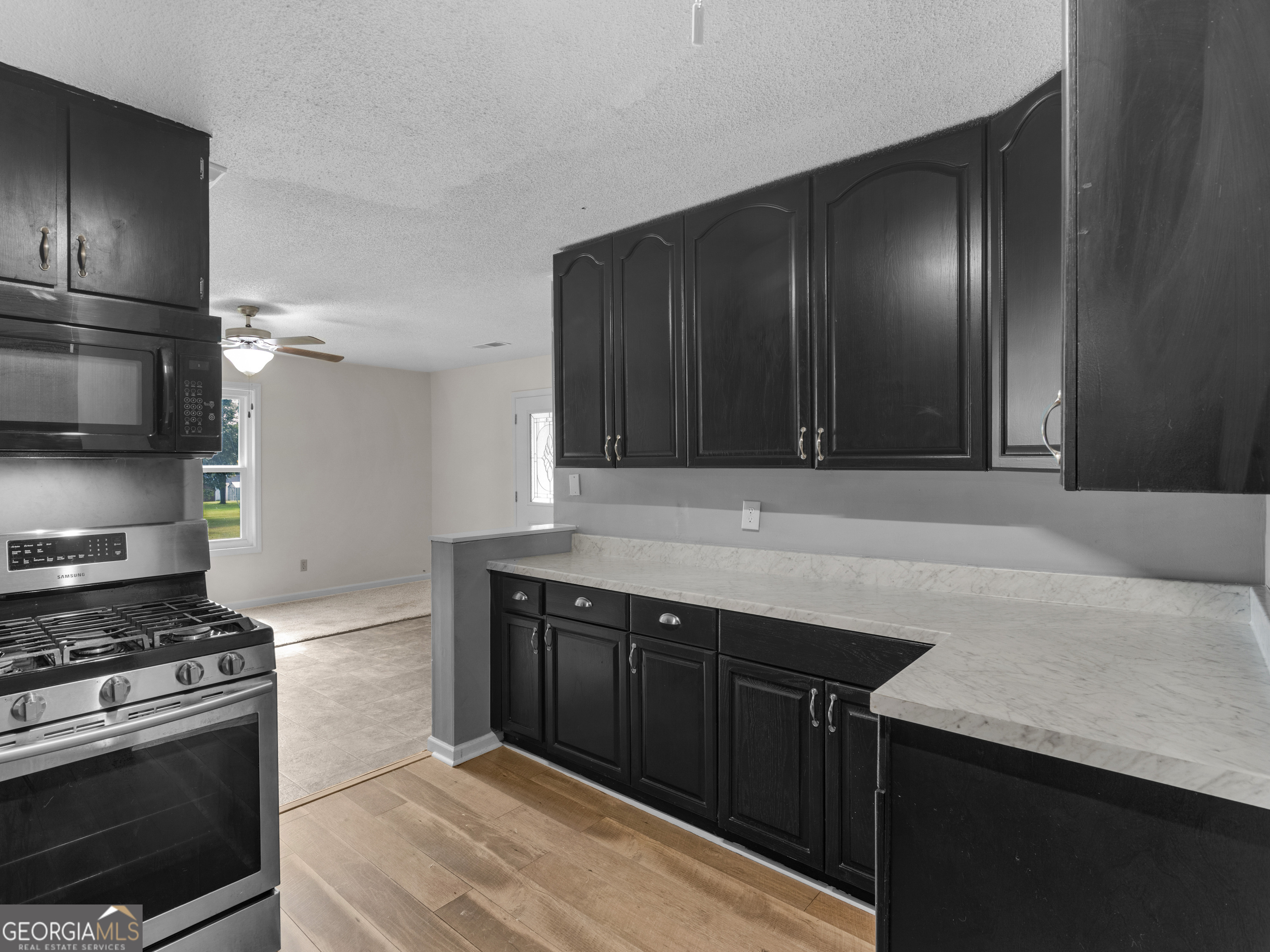 4939 Highway 19 Zebulon, GA 30295 - Photo 42 of 70 a kitchen with a stove and a refrigerator