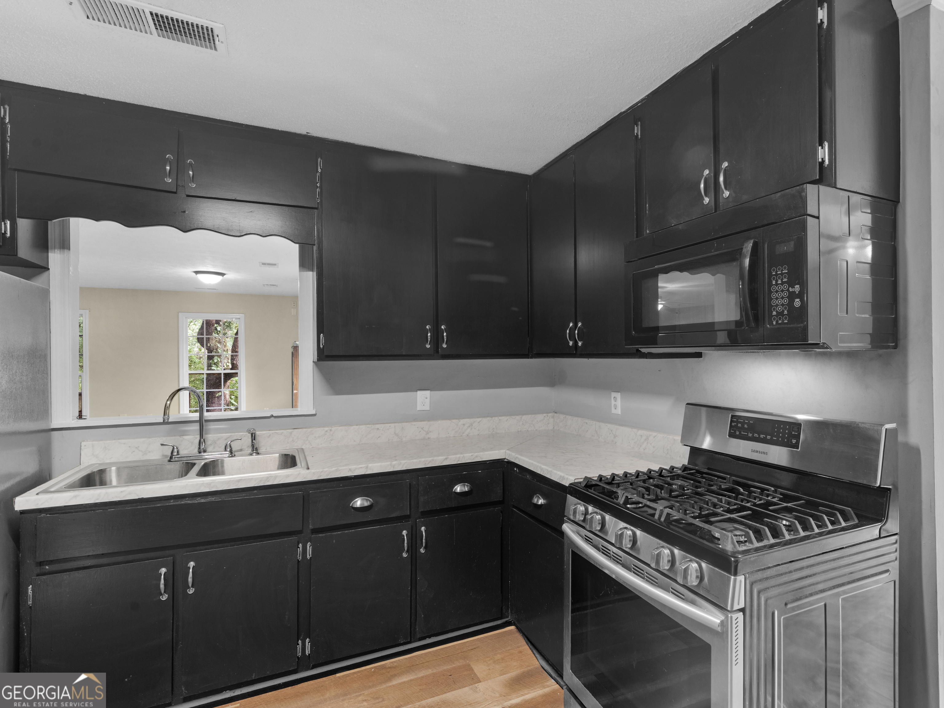 4939 Highway 19 Zebulon, GA 30295 - Photo 46 of 70 a kitchen with a sink stove and cabinets