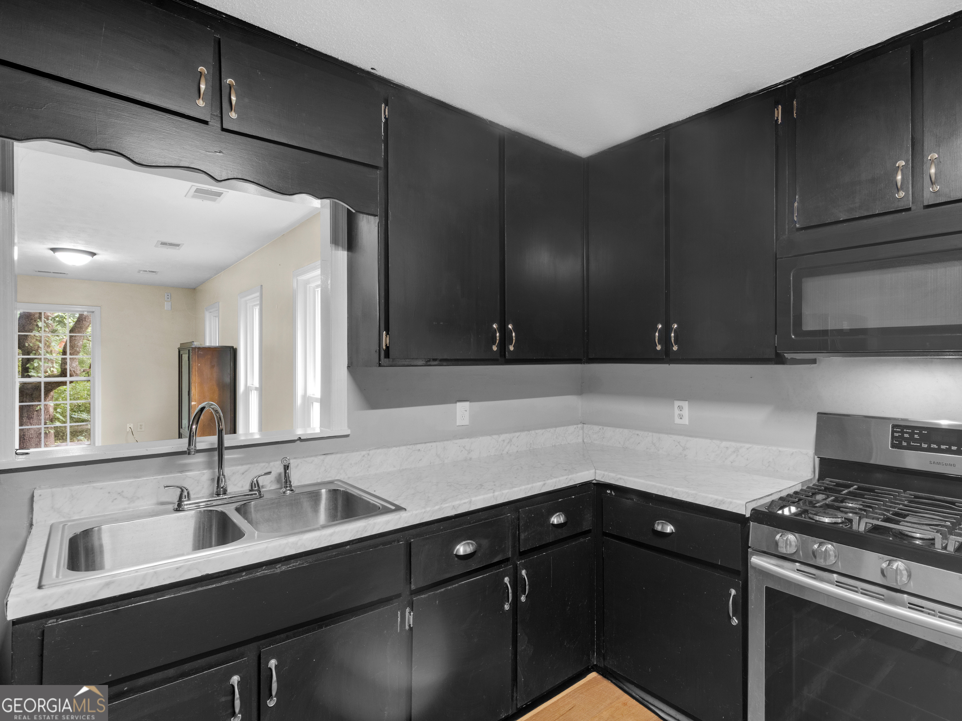 4939 Highway 19 Zebulon, GA 30295 - Photo 47 of 70 a kitchen with granite countertop a sink stainless steel appliances and cabinets
