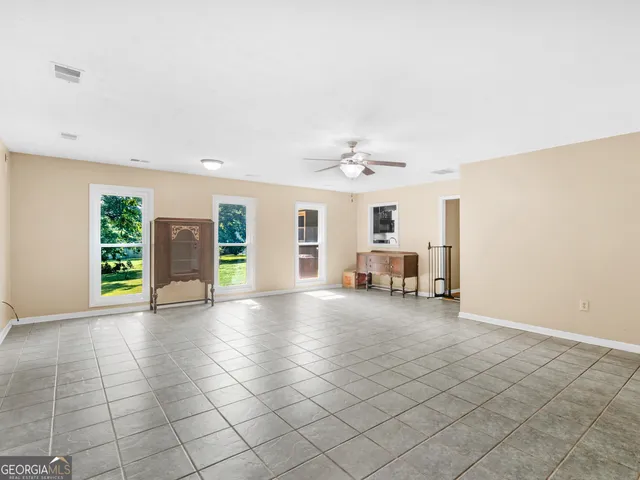 an aerial view of a house with swimming pool outdoor seating and yard