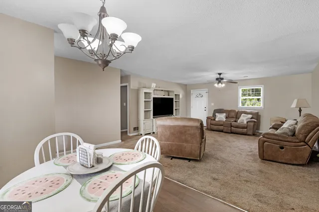 a view of a dining room with furniture wooden floor and chandelier
