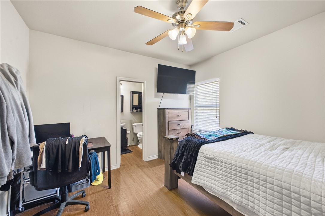 4400 Milam Street Bryan, TX 77801 - Photo 18 of 25 a bedroom with a bed furniture and a chandelier