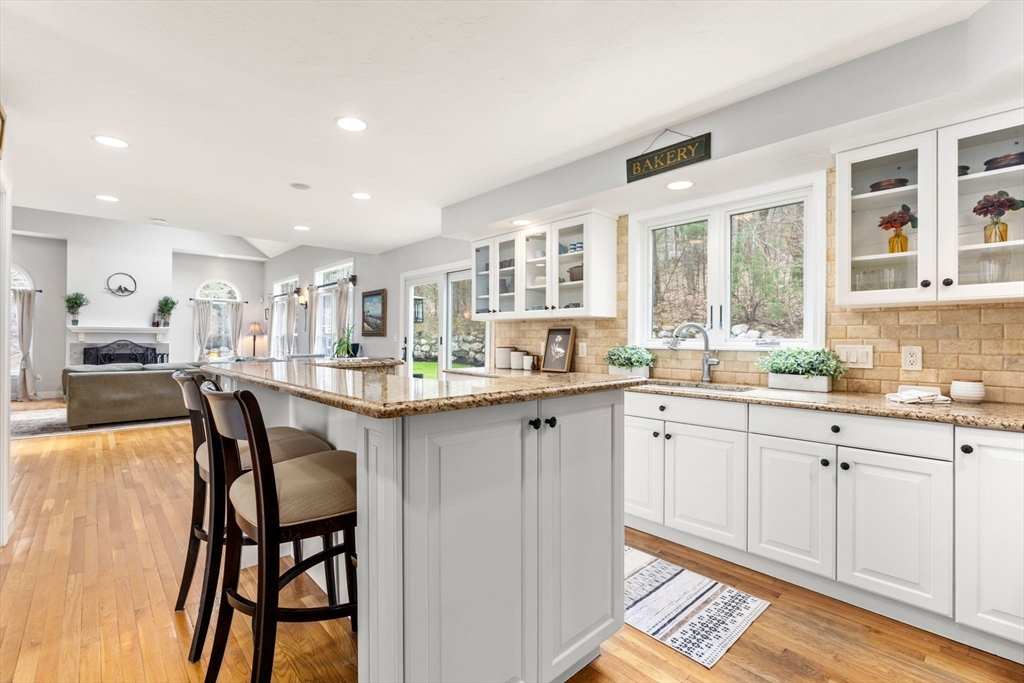 4 Ridge Road Framingham, MA 01701 - Photo 8 of 41 a kitchen with a dining table chairs cabinets and stainless steel appliances