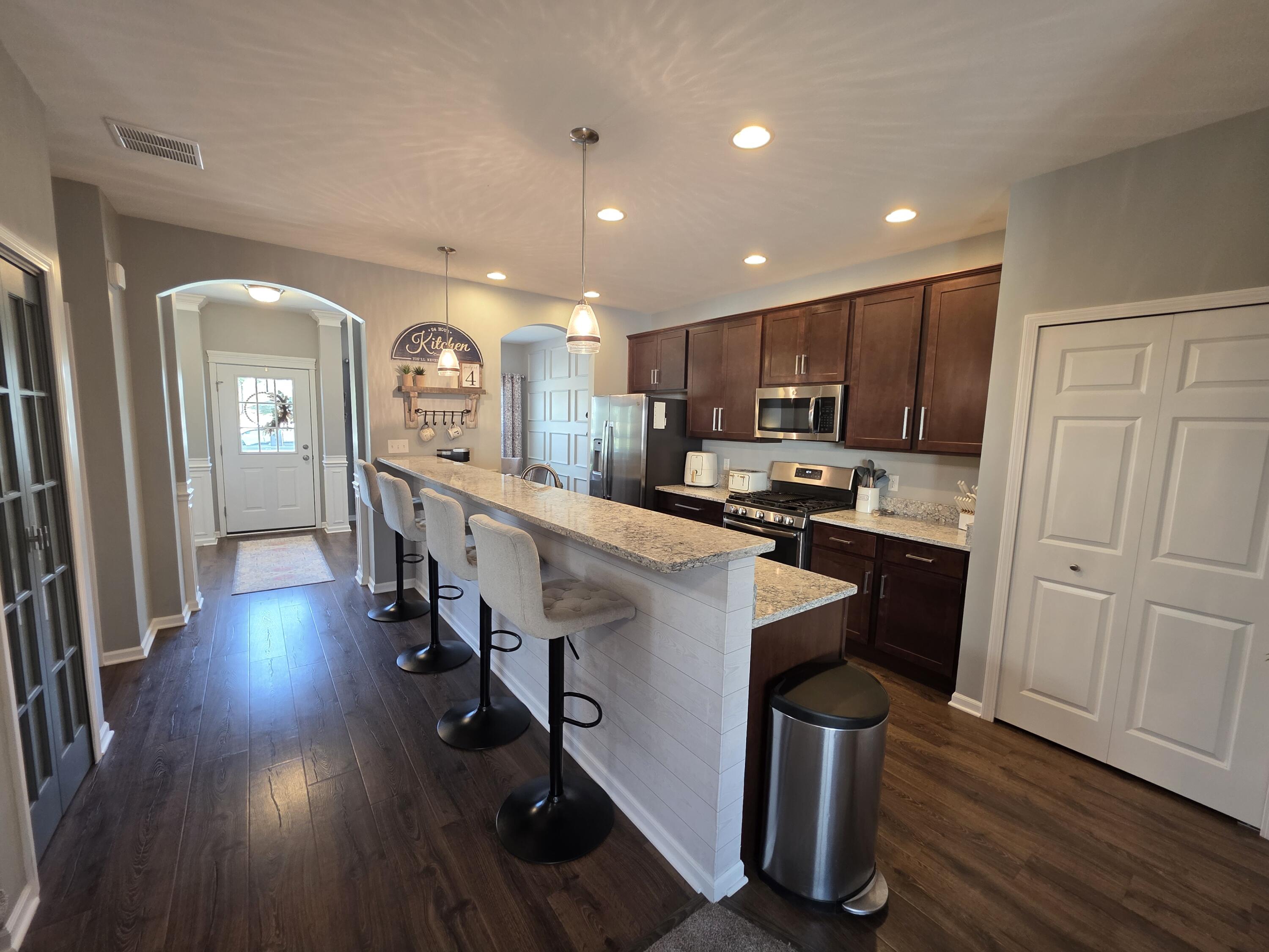 11558 Kentucky Street Crown Point, IN 46307 - Photo 11 of 39 a kitchen with counter top space a sink appliances and cabinets