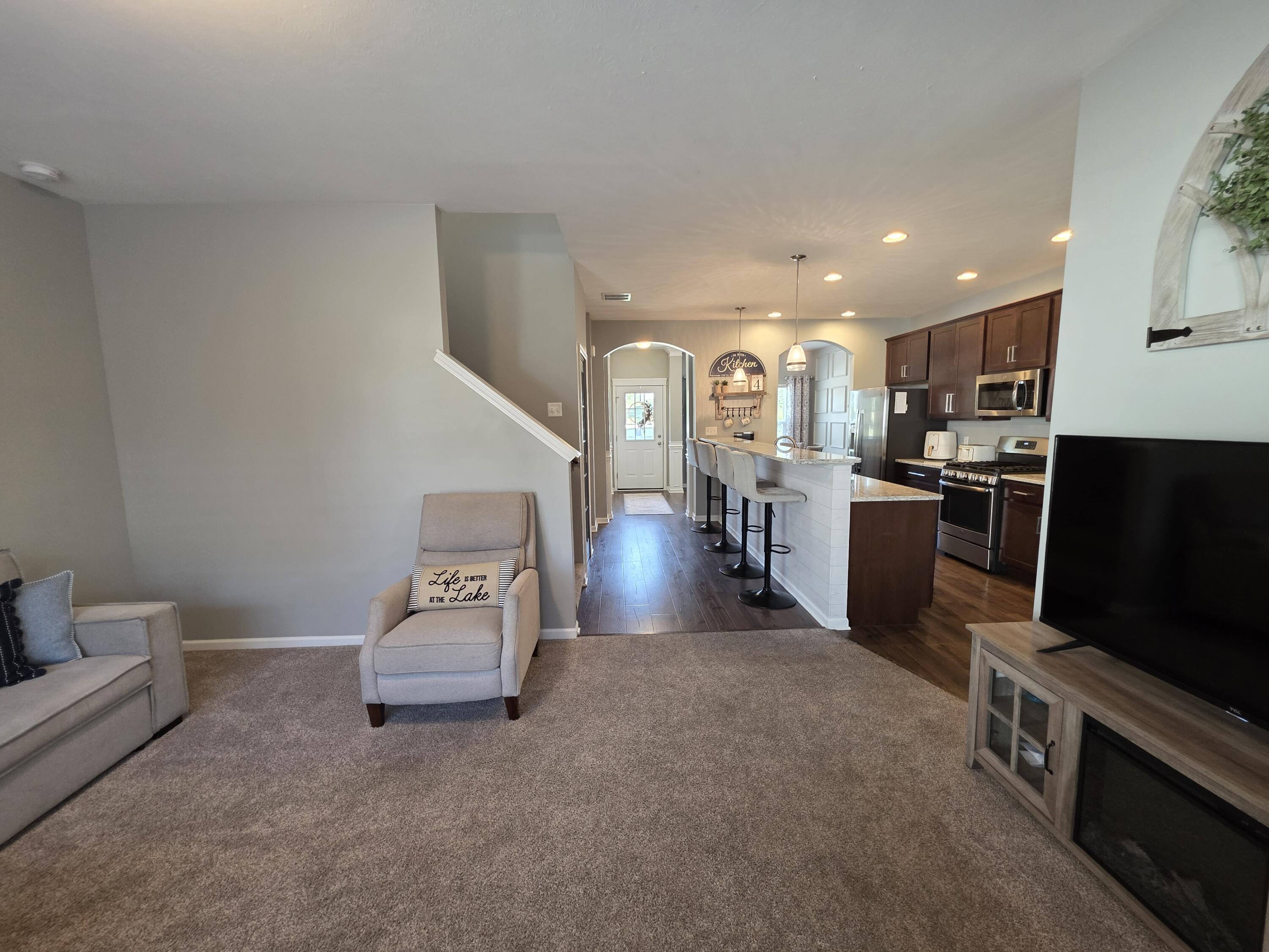 11558 Kentucky Street Crown Point, IN 46307 - Photo 15 of 39 a living room with furniture and a flat screen tv