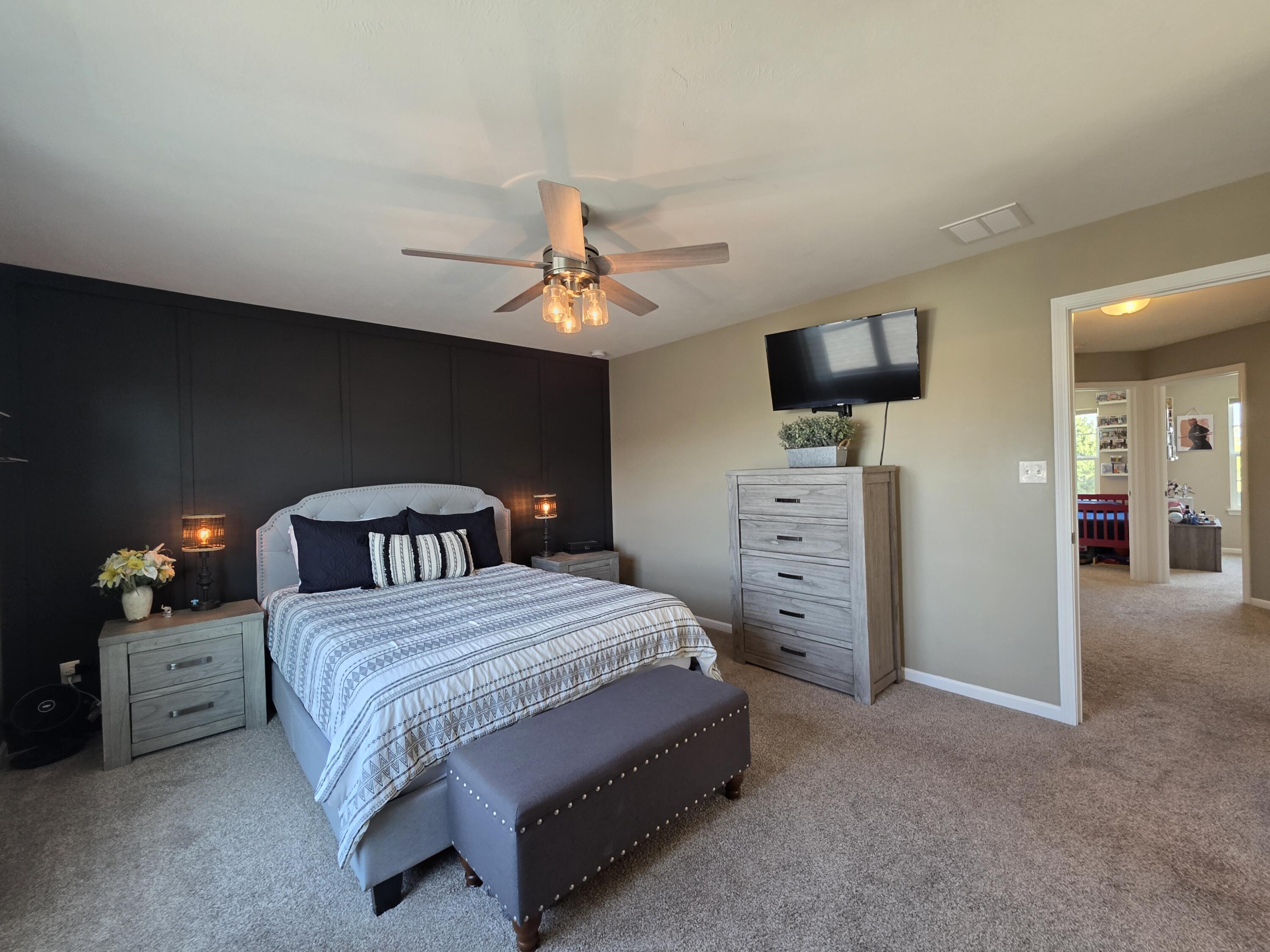 11558 Kentucky Street Crown Point, IN 46307 - Photo 23 of 39 a bedroom with a bed and a flat tv screen on dresser