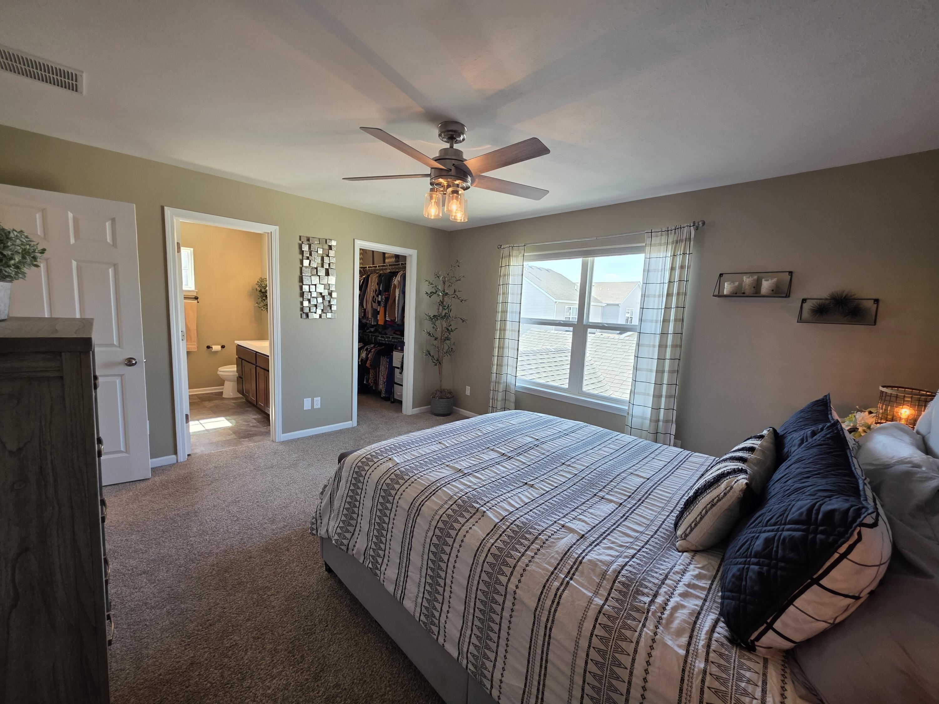 11558 Kentucky Street Crown Point, IN 46307 - Photo 24 of 39 a bedroom with a large bed and a window