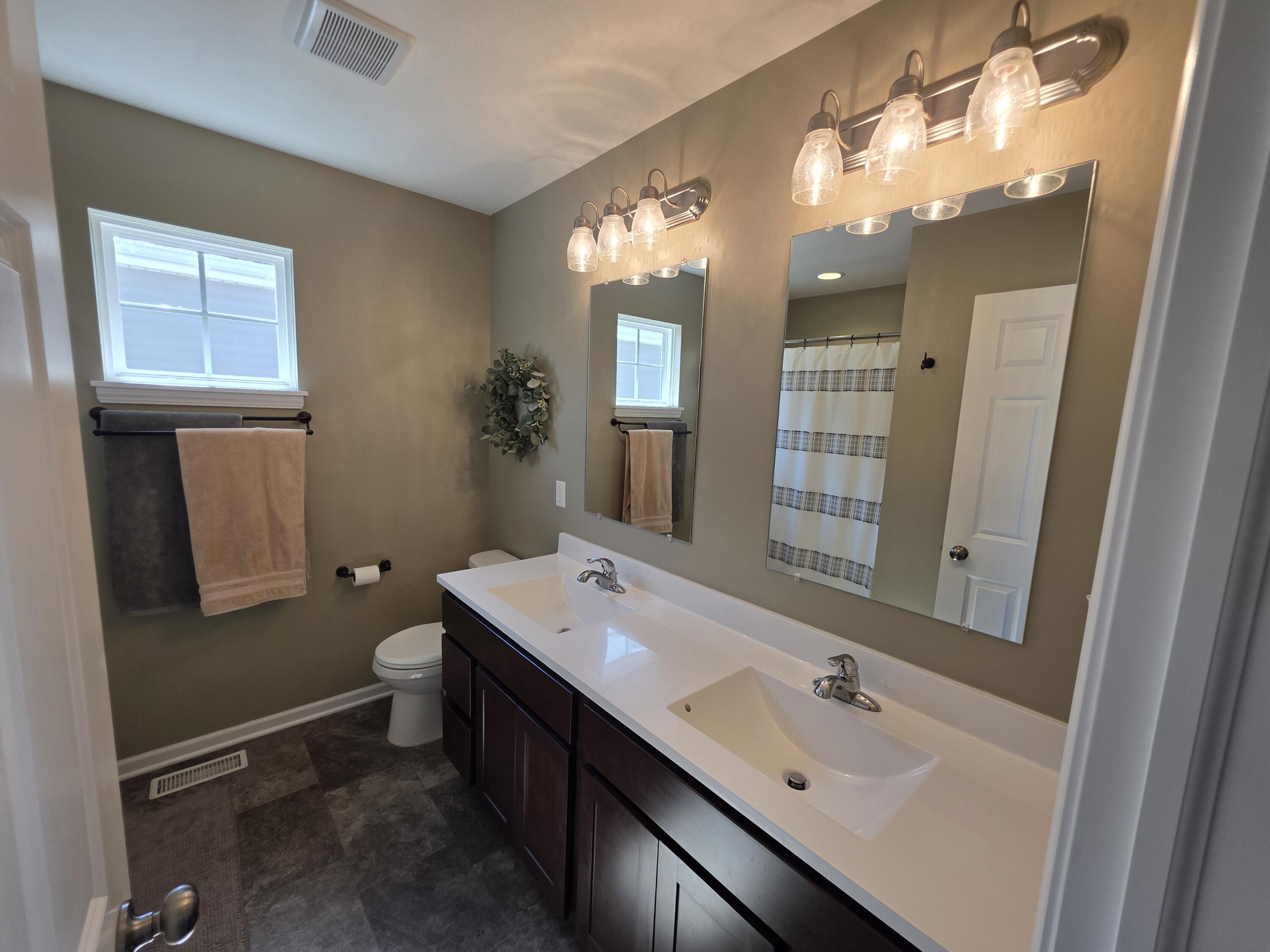11558 Kentucky Street Crown Point, IN 46307 - Photo 25 of 39 a bathroom with a sink double vanity granite and a mirror