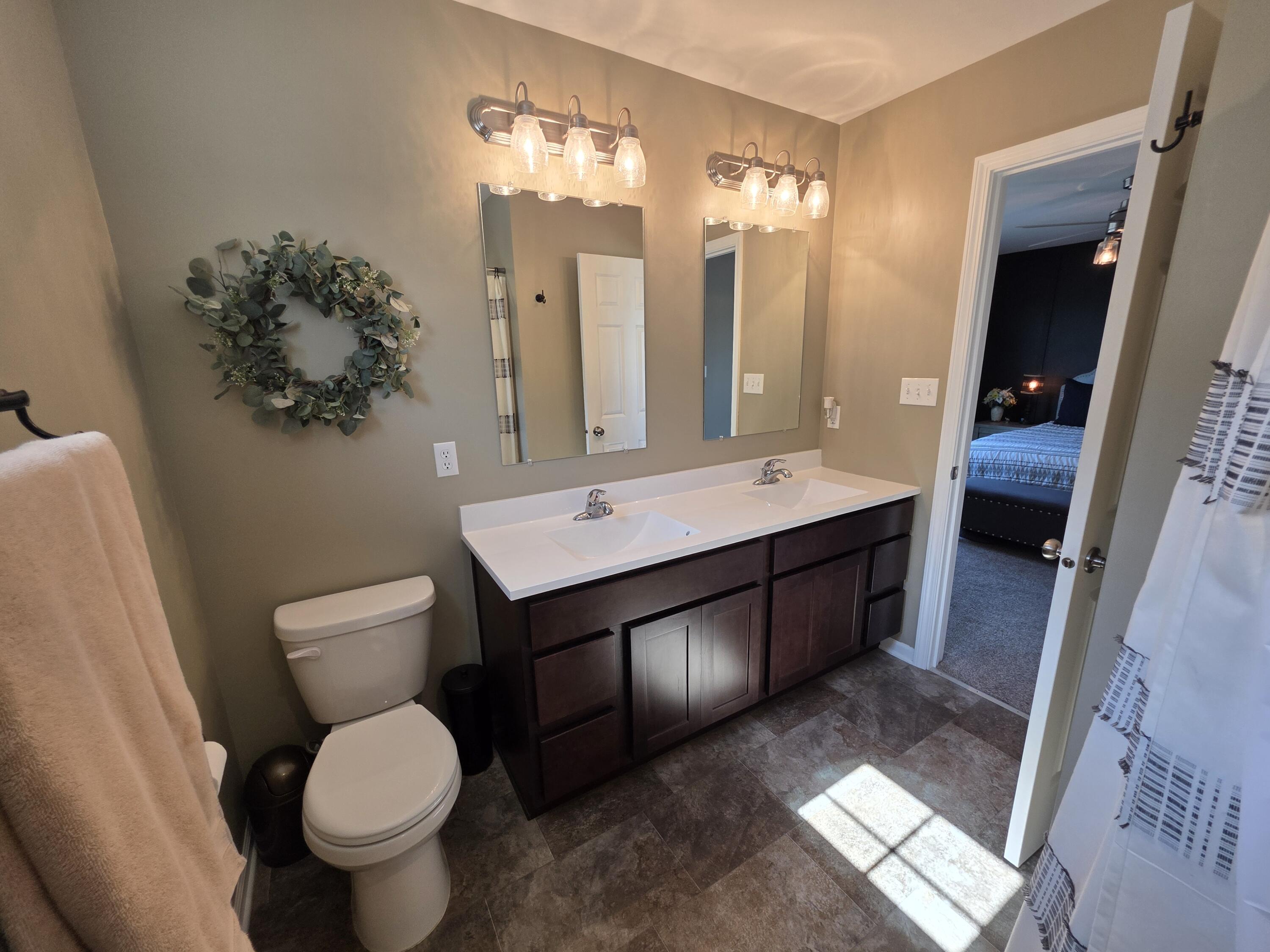 11558 Kentucky Street Crown Point, IN 46307 - Photo 26 of 39 a bathroom with a toilet sink and mirror