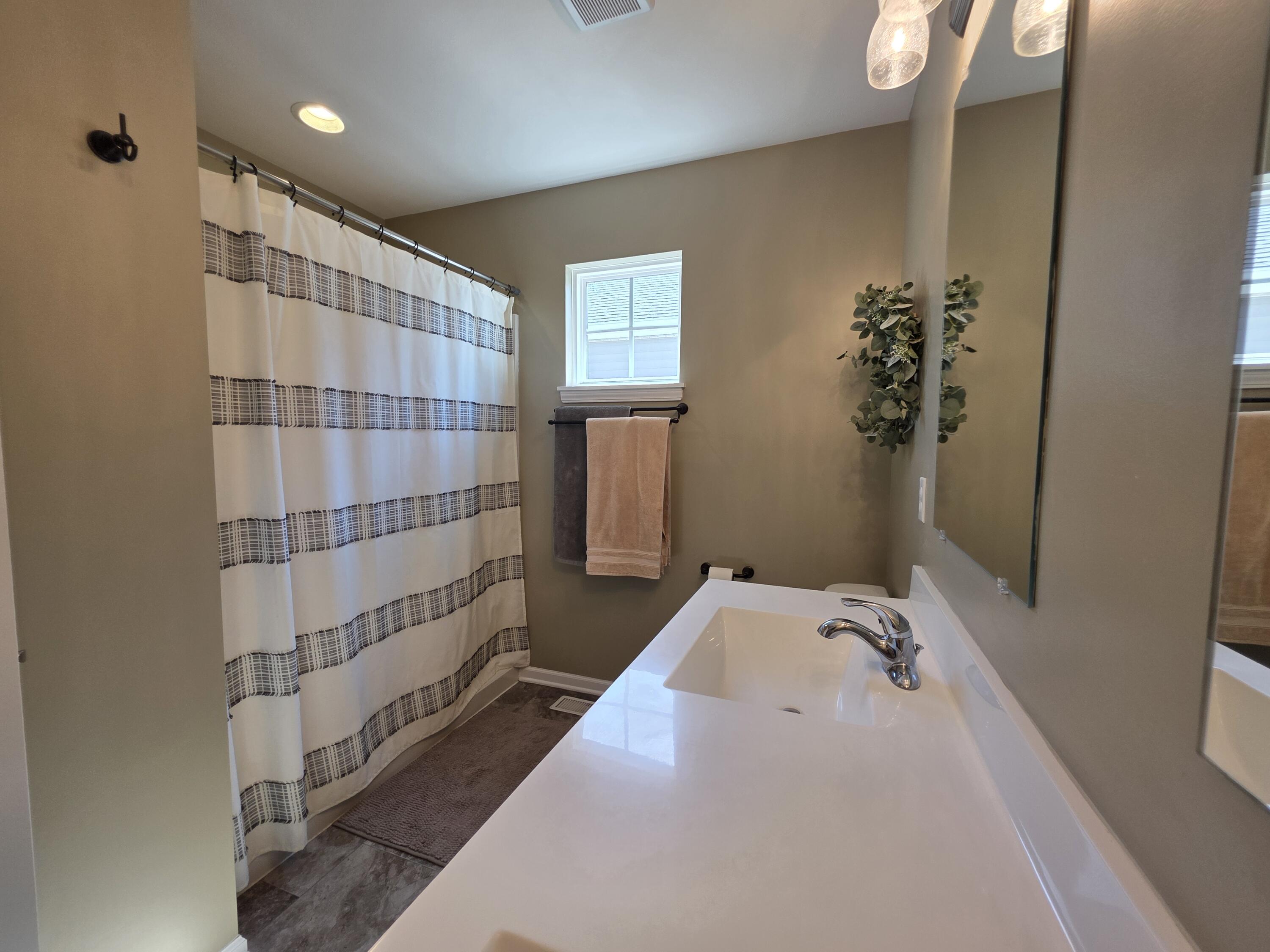 11558 Kentucky Street Crown Point, IN 46307 - Photo 27 of 39 a bathroom with a bathtub and shower