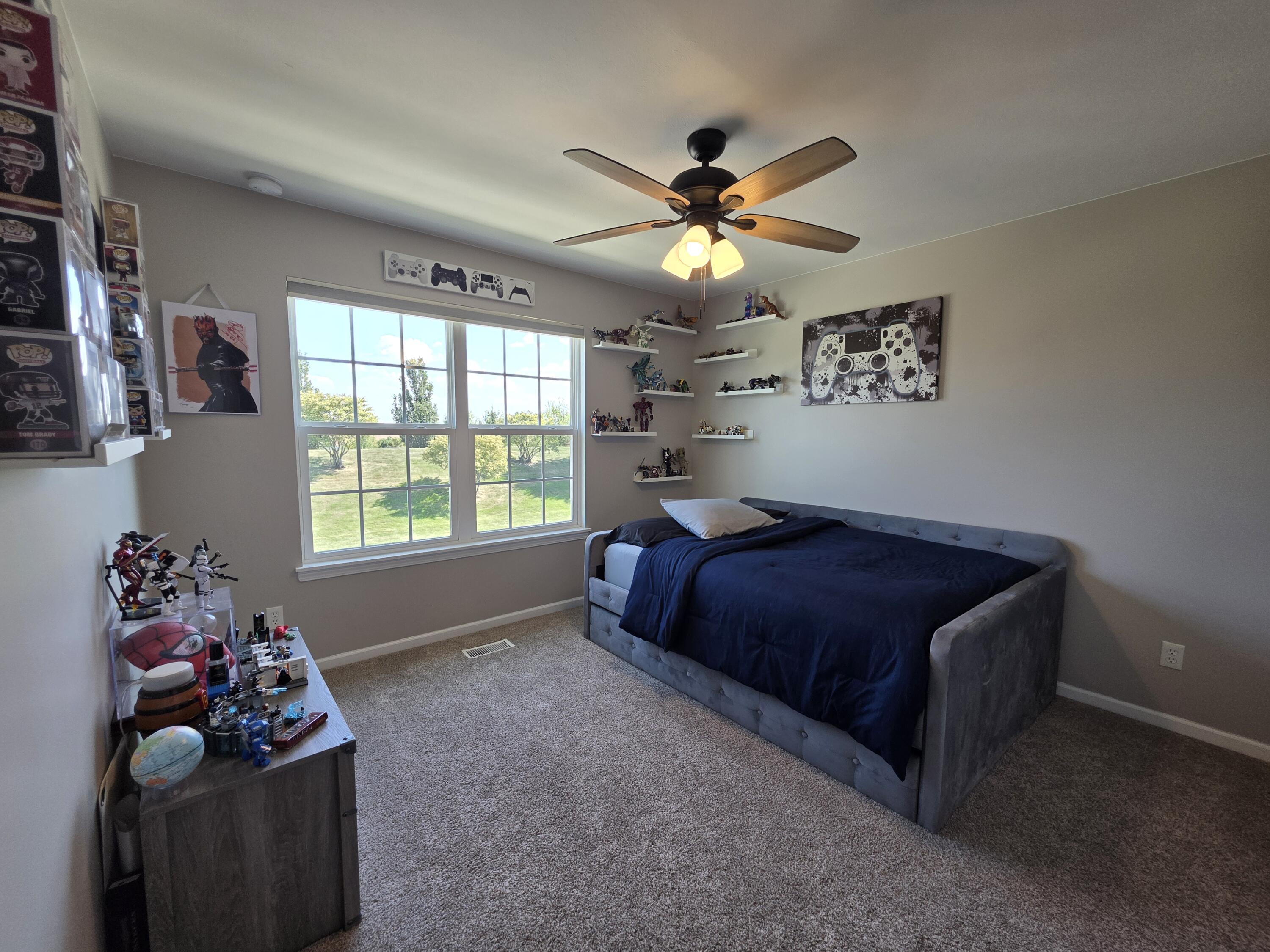 11558 Kentucky Street Crown Point, IN 46307 - Photo 29 of 39 a bedroom with a bed and a chandelier