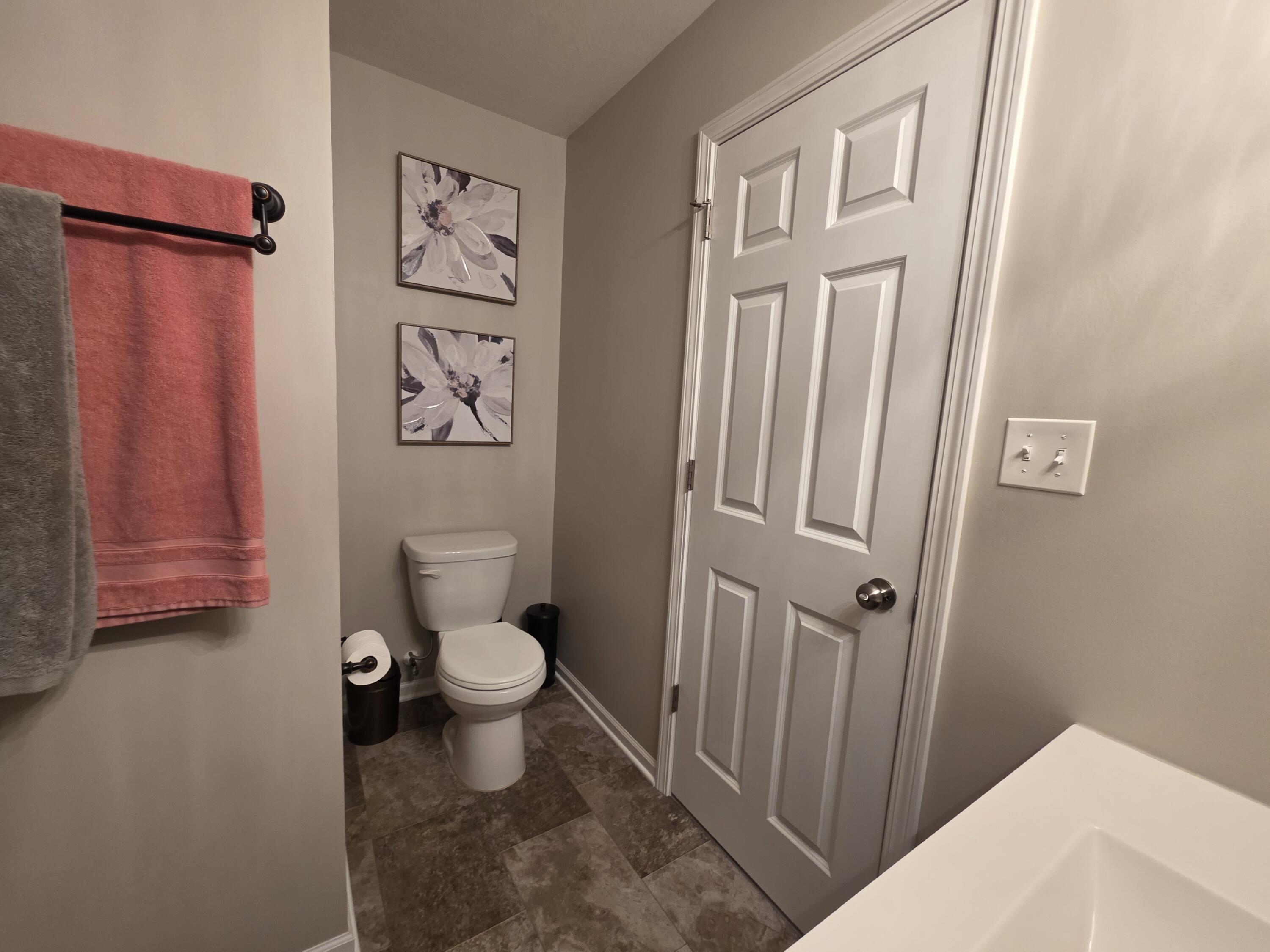 11558 Kentucky Street Crown Point, IN 46307 - Photo 33 of 39 a bathroom with a toilet and a shower curtain