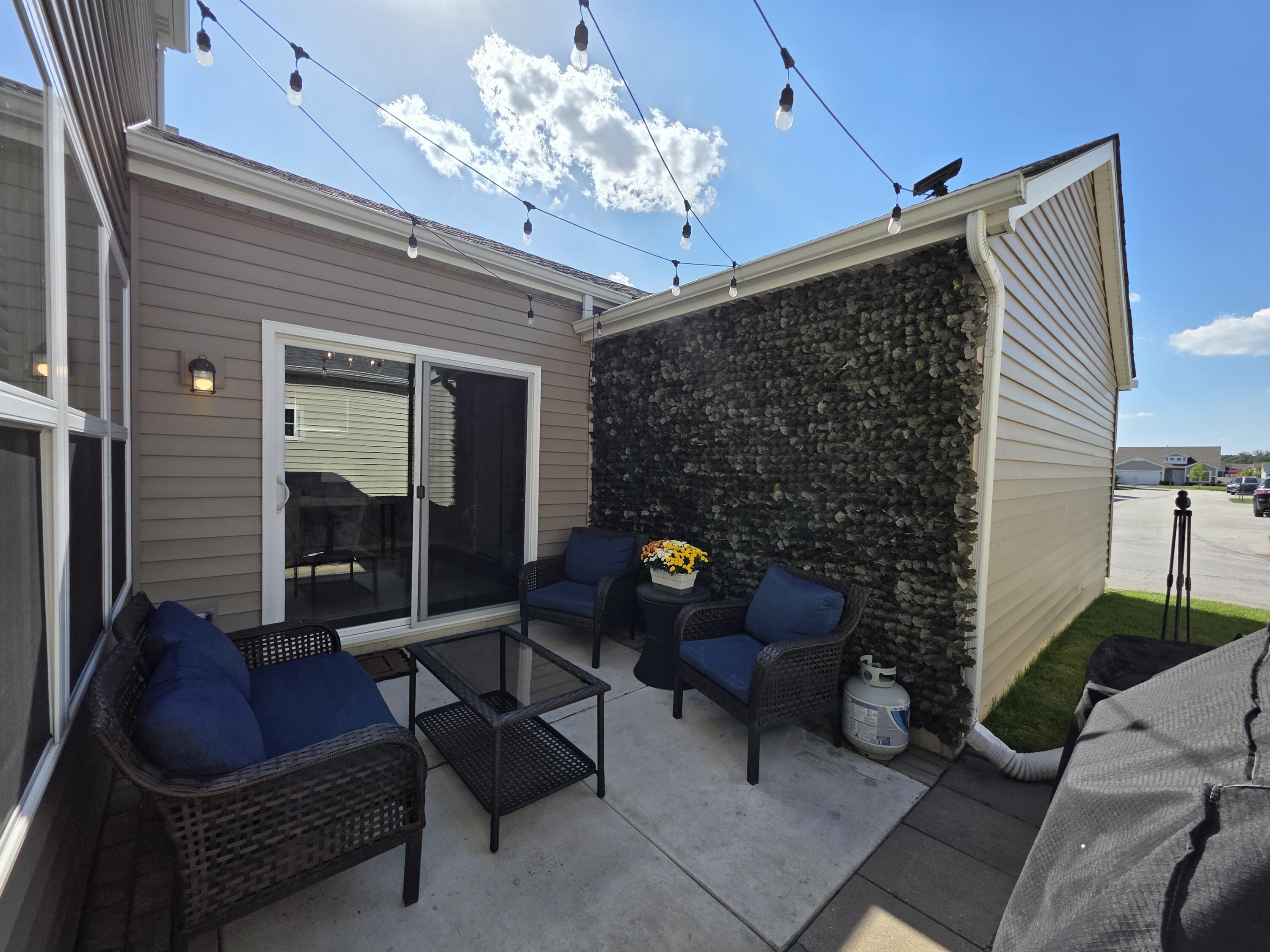 11558 Kentucky Street Crown Point, IN 46307 - Photo 37 of 39 a outdoor living space with furniture and a fireplace