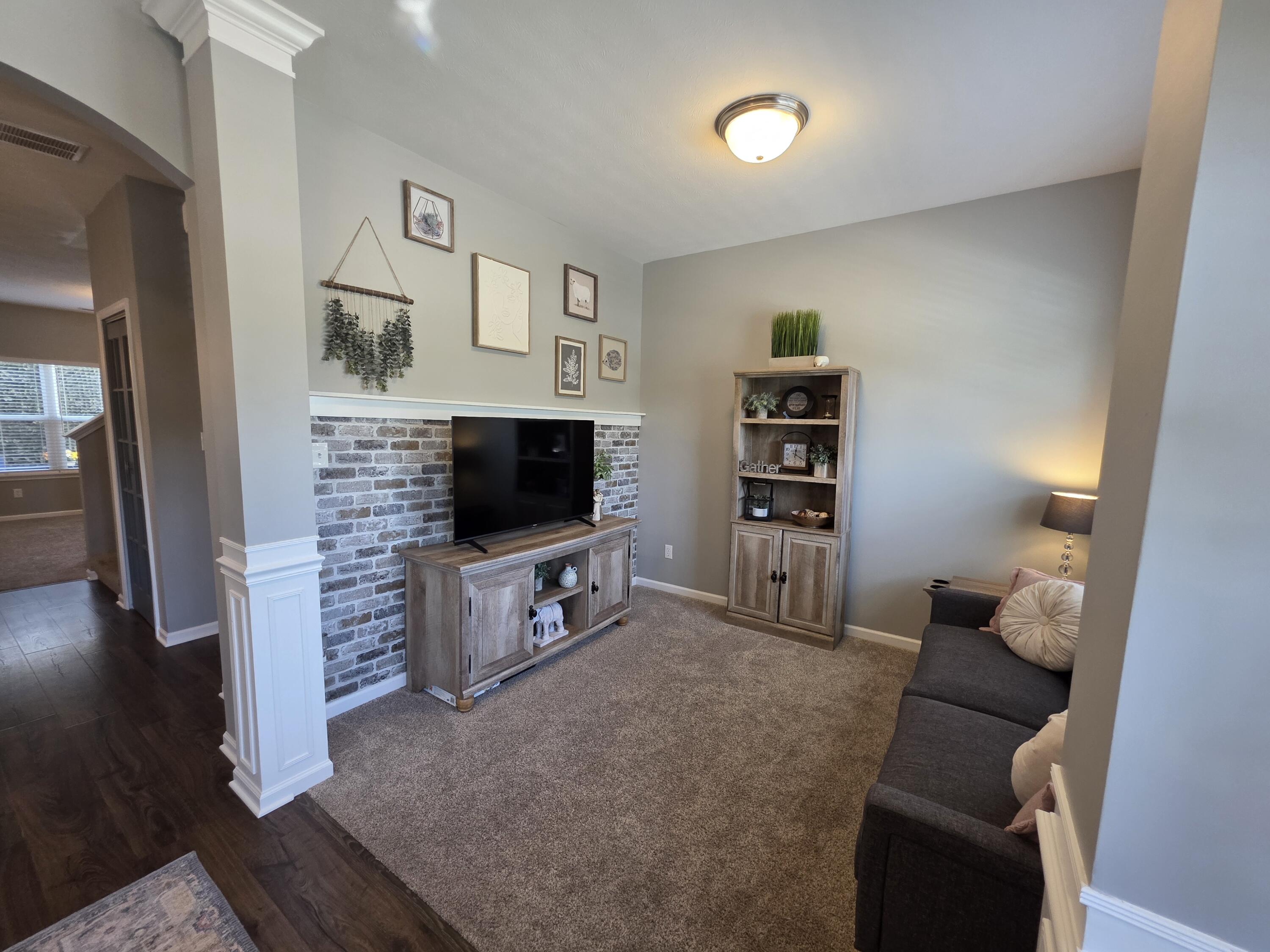 11558 Kentucky Street Crown Point, IN 46307 - Photo 9 of 39 a living room with furniture and a flat screen tv