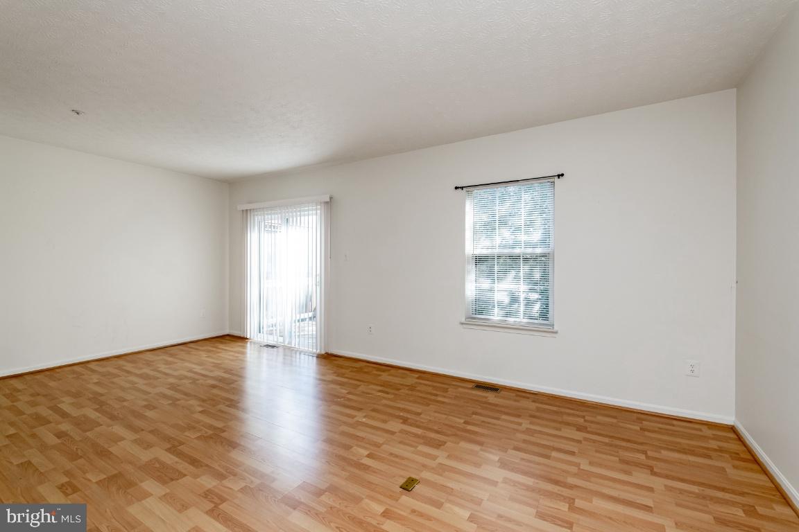 9319 Ridings Way Laurel, MD 20723 - Photo 17 of 44 Living room with slider to deck
