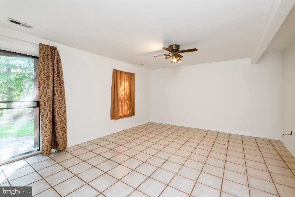 9319 Ridings Way Laurel, MD 20723 - Photo 35 of 44 Lower level family room w/ slider to patio & yard