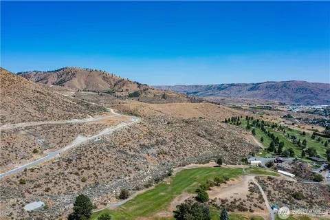 a view of a dry yard with mountains in the background