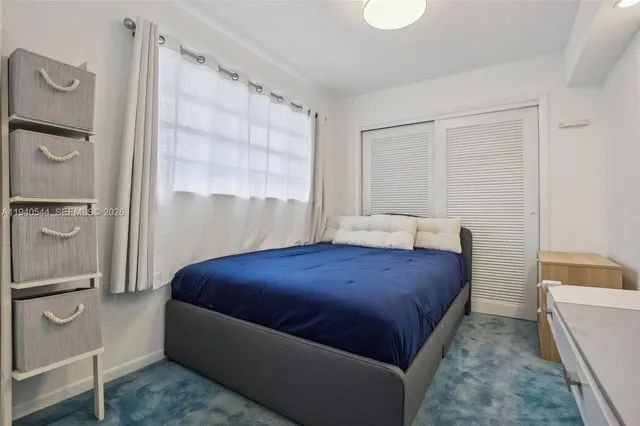 a bedroom with a bed and a couch