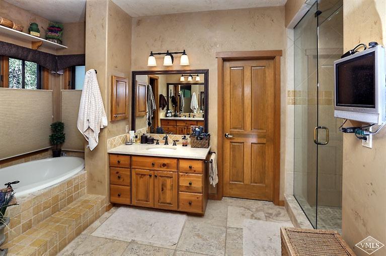 35 Buckboard Road Edwards, CO 81632 - Photo 13 of 21 a bathroom with a tub sink and mirror