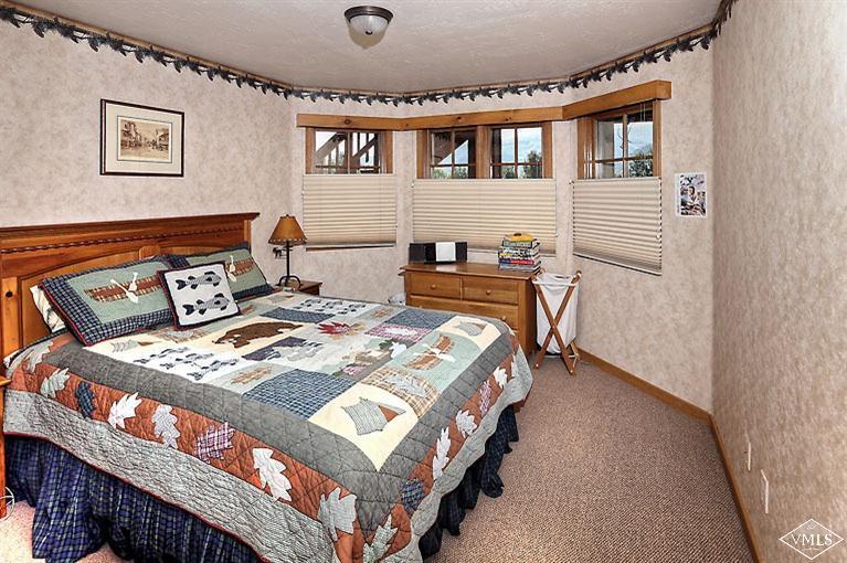 35 Buckboard Road Edwards, CO 81632 - Photo 10 of 21 a bed sitting in a bedroom next to a cabinet