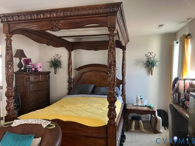 a bed room with a bed and a chair