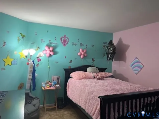 a view of a hallway to room with wooden floor