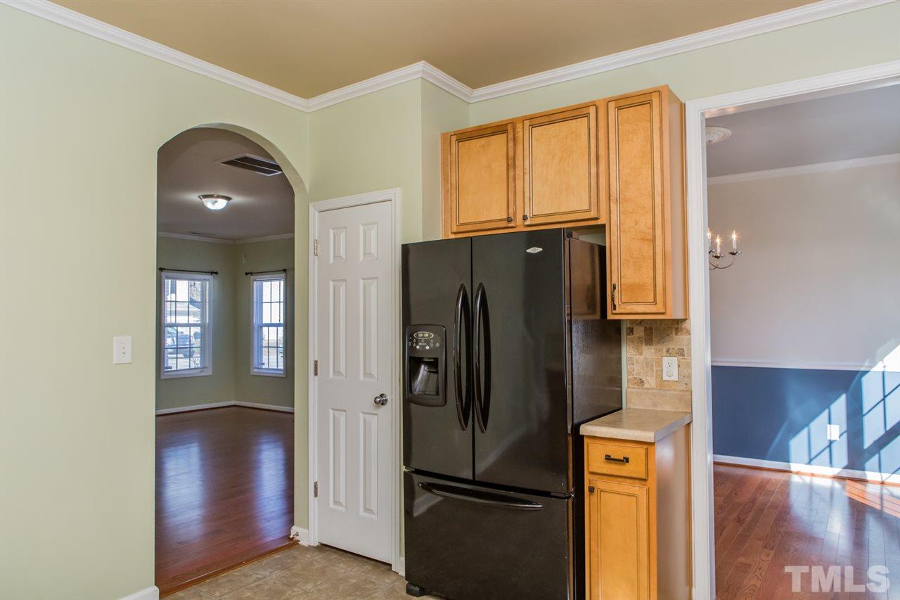 2905 Smooth Stone Trail Raleigh, NC 27610 - Photo 6 of 29 a metallic refrigerator freezer sitting in a kitchen