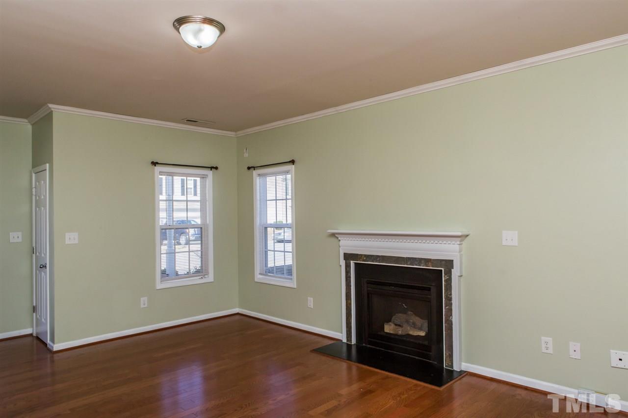2905 Smooth Stone Trail Raleigh, NC 27610 - Photo 9 of 29 an empty room with windows and fireplace
