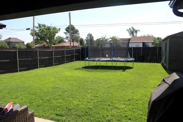 a view of a backyard with swimming pool