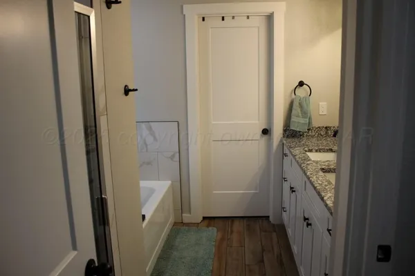 a bathroom with a shower and a sink