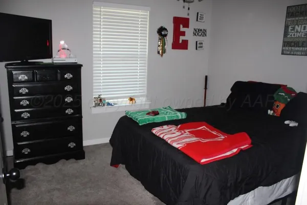 a bedroom with a bed and flat screen tv