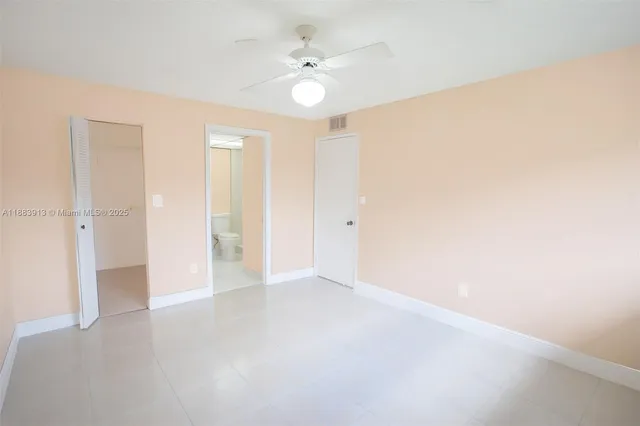 a white toilet sitting next to a bath tub